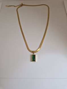 Gold snake chain necklace with beautiful green pendant Stainless steel and tarnish free Snake Chain Necklace Gold With Pendant, Snake Necklace Gold, Modern Green Metal Necklaces, Modern Green Rectangular Pendant Jewelry, Green Tarnish-resistant Pendant Necklace, Stainless Steel Snake Chain Necklace, Elegant Green Stainless Steel Necklace, Modern Green Pendant Jewelry, Green Pendant Chain Necklace As Gift