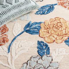 a close up of a rug with flowers on it