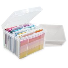 a plastic container filled with lots of different colored papers