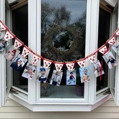 a photo bunting is hanging on the window sill