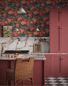 a kitchen with pink cabinets and marble counter tops