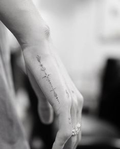 a woman's hand with a tattoo that reads, i love you to the moon and back