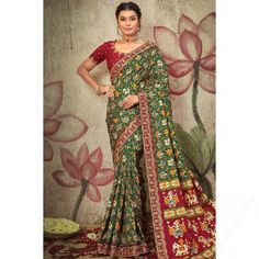 A stylish interpretation of ethnic glamour and contemporary style, this dark green satin saree which is surely to set you apart from the rest. This round neck and half sleeve blouse beautified with zari, dori, and sequins work. It is teamed up with satin patola saree in dark green color perfectly formed using Woven zari, beads, dori, sequins, zari, and printed work. This saree blouse can be customized up to the maximum size available in inches 58 around the bust. Contemporary Saree, Bollywood Sarees Online, Patola Saree