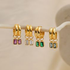 Introducing our elegant Dangling Gemstone Hoop Earrings, designed in gold finish with a unique twist - Removable Emerald-Cut Gemstones! These earrings blend classic charm with modern versatility, letting you create your own statement ✨ Material: High Quality Solid 925 Sterling Silver Finish: Sterling Silver ∙ 18K Gold Featuring minimalist ~15mm Hoop Earrings with Emerald-Cut, Removable ~7x5mm CZ Gemstones Sold as a Pair Part of our Birthstone Collection Final Sale SKU: RR-ER400 Emerald Cut Solitaire Ring, Initial Tag Necklace, Sideways Initial Necklace, Emerald Birthstone, Gemstone Hoop Earrings, Aquamarine Blue, Ear Jewelry, Purple Amethyst, Initial Necklace