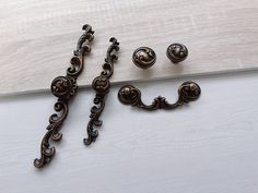 an ornate metal object sitting on top of a white table next to a wooden board