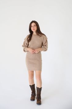 A ribbed knit mini dress with the following features: Round neckline. Bishop sleeves with ruffle detailing. Loose fit. Model Info: Height: 5 ft 8 in wearing Size S. Fall Ribbed Mini Bodycon Dress, Fall Bodycon Knit Mini Dress, Chic Ribbed Knee-length Mini Dress, Ribbed Mini Bodycon Dress For Fall, Chic Knee-length Ribbed Mini Dress, Stretch Mini Dress With Ruffles For Winter, Fall Ribbed Mini Dress, Casual Ruffle Sleeve Mini Dress For Fall, Ribbed Knit Mini Dress