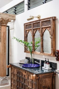 a bathroom with a sink, mirror and wooden cabinet in it's centerpiece