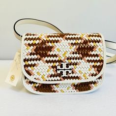 Tory Burch Leather Woven Britten Small Saddle Crossbody Bag Product Details: Nwt. Pristine. Leather Multicolor With Ivory, Brown, Pink & Mustard Top Fold Over Flap With Magnetic Closure Fabric Lined Interior Has Front & Rear Slip Pocket Strap: Removable And Adjustable Leather Strap With Max Drop Of 22” Dimension: 8" (W) X 6" (H) X 2.75" (D) White Woven Leather Travel Bag, Designer White Shoulder Bag With Woven Leather, White Woven Leather Bag, Tory Burch Eleanor Bag, Tory Burch Kira Chevron, Tory Burch Shoulder Bag, Kira Chevron, Tory Burch Purse, Tory Burch Kira