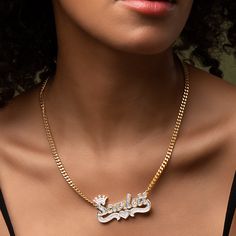 Our popular Double Plated Iced Princess Crown Name Necklace boasts a chic and elegant design, handcrafted to perfection. The model showcases the necklace with an 18-inch Cuban chain (see video for reference). You can personalize this item with Letters, Numbers, and Roman Numerals and choose from chain lengths of 14", 16", 18", and 20". Each chain features a lobster clasp closure for secure wear.Chain width:Cuban Chain - 3.7 mmFigaro Chain - 3 mmRope Chain - 2.3 mm XO Chain - 5 mm 14k Gold Necklace With Curb Chain Style Fine Jewelry, 14k Gold Curb Chain Necklace, Elegant Personalized Link Necklaces, Fine Jewelry Cuban Link With Adjustable Chain, Fine Jewelry With Adjustable Cuban Link Chain, Gold Plated White Gold Chain Necklace For Anniversary, White Gold Plated Chain Necklace For Anniversary, Anniversary Nameplate Necklace With Adjustable Chain, Classic Gold Diamond Name Necklace