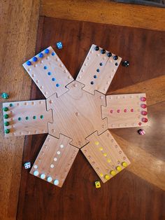 an overhead view of a wooden board game on the floor with dices scattered around it