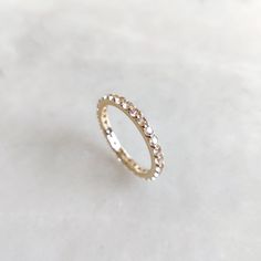 This stunning full eternity ring is set in 14k Solid Yellow Gold with Natural White Topaz with utmost precision. It is an unique statement gemstone ring for nearly every occasion and is completely hassle-free jewelry. ITEM DETAILS * Gem: White Topaz * Gem Size: 2mm * Gem Shape: Round ,28pcs * Gem Weight: 1.20 carats * Gold Purity: 14KT * Gold Weight: 1.54 gram * Total Weight of the Ring: 1.78 gram The Gold purity is guaranteed and it comes with authentic 14KT gold hallmark. Since my items are handmade, they are absolutely nickel and lead free. CUSTOMIZATION * Gemstone customization is available, it can be substituted with a gem of your choice. It is available in gemstones such as Amethyst, Topaz, Onyx, Citrine, Garnet, Tourmaline, Aquamarine and many more. Kindly drop me a message for the Cubic Zirconia Eternity Band With Halo For Promise, Infinity Diamond Eternity Band As Gift, Cubic Zirconia Halo Eternity Band Promise Ring, Promise Ring Cubic Zirconia Eternity Band With Halo, Diamond Infinity Eternity Band As Gift, White 14k Gold Eternity Band For Promise Ring, White Halo Eternity Band Promise Ring, White Halo Eternity Band For Promise, White Eternity Band With Vs Clarity