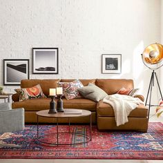 a living room filled with lots of furniture and pictures on the wall next to a window