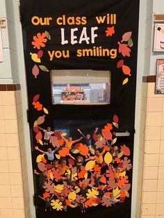 a door decorated with fall leaves and the words, our class will leaf you smiling