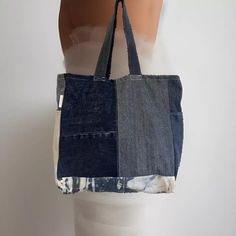 Denim handmade shoulder bag width 39cm length 40cm.  ✨Each bag is a one of a kind as it is made from responsibility sourced denim, and made by hand in our UK based studio. ✨The bags are a square shape and have a panel on the bottom which allows for plenty of storage space. There is also a pocket on each side panel. Our super cute "reworked by Ruthie" label is featured on the side of the bag. ✨The bags are made of a single layer of denim and are finished with an overlocked stitch on the inside of Everyday Rectangular Denim Bag, Daily Use Dark Wash Cotton Shoulder Bag, Everyday Dark Wash Cotton Shoulder Bag, Rectangular Denim Blue Shoulder Bag For Everyday Use, Denim Blue Cotton Shoulder Bag For Everyday Use, Everyday Denim Blue Cotton Shoulder Bag, Rectangular Denim Blue Cotton Shoulder Bag, Dark Wash Canvas Shoulder Bag For Everyday, Eco-friendly Rectangular Denim Bag