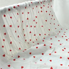 red hearts on white sheer curtains in a room