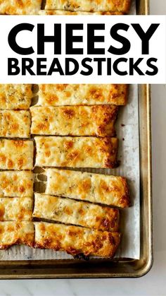 cheesy breadsticks on a baking sheet with text overlay that reads cheesy breadsticks