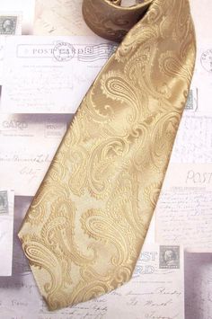 This tie is made of 100% silk, 3.50" wide at it's widest point and 58" long - standard length and width. Hand rolled and sewn by hand. Elegant Semi-formal Neckwear With Paisley Print, Elegant Black Tie Suit Accessories With Paisley Print, Elegant Semi-formal Ties With Paisley Print, Elegant Semi-formal Paisley Print Ties, Elegant Formal Ties With Paisley Print, Elegant Paisley Print Tie As A Gift, Elegant Paisley Print Ties As Gift, Gold Tie For Black Tie Events, Elegant Wedding Ties With Paisley Print