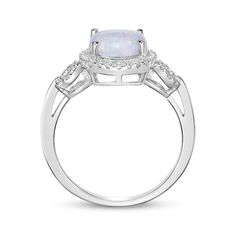 A bold lab-created opal cabochon gives this chic ring a mesmerizing look. Crafted in sterling silver The oval-cut lab-created opal centerpiece is haloed by white lab-created sapphires Loops of white lab-created sapphires decorate the slender shank for added sparkle Oval Opal Rings With Polished Finish, Fine Jewelry Oval Opal Ring With Polished Finish, Oval Opal Ring With Polished Finish In Fine Jewelry, Oval Opal Ring With Polished Finish, Modern Oval Opal Ring, Oval Cabochon Opal Ring In White Gold, Oval Cabochon White Gold Opal Ring, Silver Opal Rings With Center Stone, Oval White Gold Opal Cabochon Ring