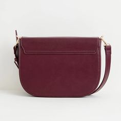 A thoughtfully designed, spacious messenger bag crafted from certified vegan leather in a rich burgundy. This bag strikes the perfect balance between style and utility, making it a versatile choice for both work and casual use. It features an adjustable cross-body strap, a convenient zipped inner pocket, and a secure magnetic fastening to ensure your essentials are well-protected. We also have the same bag in tan, and a smaller saddle bag in the same colourways Key features: Approx. 29 (L) x 21 Versatile Satchel Saddle Bag For Work, Satchel Saddle Bag With Adjustable Strap For Work, Workwear Satchel Saddle Bag With Adjustable Strap, Workwear Satchel Saddle Bag With Detachable Strap, Versatile Burgundy Satchel Bag, Workwear Saddle Bag With Adjustable Strap, Workwear Saddle Bag With Detachable Strap, Versatile Saddle Bag For Work, Versatile Workwear Saddle Bag