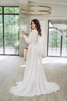 Step into your special day with the grace of a princess 👑, even before you put on your wedding gown. Our exquisite collection of bridal boudoir robes and nightgowns is designed to make every bride feel cherished and one-of-a-kind 💖. From joyful moments with your bridal party to quiet, reflective minutes before the mirror, our luxurious pieces add a touch of elegance and comfort to these precious moments. ✨ Elegance and Comfort Each robe and nightgown is crafted from the finest fabrics, includi Bridal Gown With Lace Back, Elegant Chiffon Wedding Gown, Bride's Gown With Lace Back, Long Sheer Wedding Dress, Sheer Long Wedding Dress, Ethereal Wedding Gown With Sheer Bodice, Sheer Flowy Floor-length Gown, Floor-length Sheer Flowy Gown, Flowy Wedding Dress With Sheer Bodice