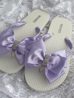 These beautiful flip flops are wrapped in lavender satin ribbon, and adorned with a matching satin ribbon bow and accent with a rhinestone strip. Ribbon color is lavender  if you are needing other colors of ribbon or decoration please contact me and will be happy to accommodate you! Sizes are for kids and adults. All flip flops are handmade to order and the production time 1 to 2 weeks and then please allow additional time for shipping. Amazing for beach, weddings, flower girl or a fancy event, Rhinestone Wedding Sandals, Flower Girl Bow, Purple Flip Flops, Purple Wedding Shoes, Bridal Flip Flops, Fancy Event, Wedding Flip Flops, Bow Flip Flops, Satin Ribbon Bow