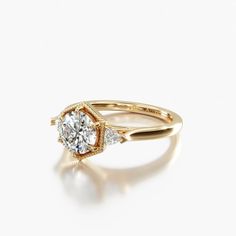 an engagement ring with two diamonds on the side, set in 18k rose gold