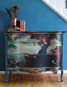 an old dresser has been painted with colorful designs