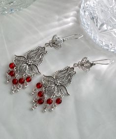 Carnelian Beads Silver Tulip Fan Floral Earrings, 925 Sterling Artisan Handmade Red Dangle Drop Chandelier Statement Rose Flower Earrings Crystal earrings, birthday gift her, red beads earrings Material: 925 Sterling Silver (NICKEL FREE) Length, Drop and Width: 8.1cm X 5.2cm X 2.6cm // 3.2 Inches X 2 Inches X 1 Inches FAST AND TRACKABLE SHIPPING FOR ALL EU COUNTRIES AND USA. The Carnelian Beads Silver Tulip Fan Floral Earrings are a testament to artisan craftsmanship and exquisite design. Made with meticulous attention to detail, these earrings feature a stunning combination of carnelian beads and 925 sterling silver. The carnelian beads add a vibrant touch of red, while the silver tulip fan floral design adds an intricate and elegant element to the earrings. The dangle drop chandelier sty Red Bead Earrings, Drop Chandelier, Eu Countries, Red Beads, Carnelian Beads, Beads Earrings, Presents For Mom, Statement Ring Silver, Holiday Earring