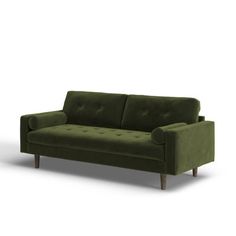 a green couch sitting on top of a white floor