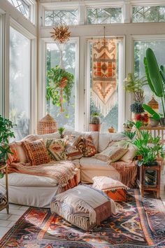 a living room filled with lots of furniture and plants on top of windowsills