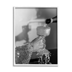 black and white photograph of someone pouring water into a glass