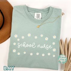 School Nurse shirt, perfect for back to school! Sizing runs true to size, but please refer to the size chart for measurements. You can size up 2xs sizes for that t-shirt dress style. This is printed directly onto the fabric so colors will be more of a 'distressed' looked. I find that this t-shirt material becomes softer after washing it!  - 100% ringspun cotton ( pre-shrunk) -Loose fit -Sewn-in label -Runs true to size *CARE INSTRUCTIONS* Machine wash: warm (max 40C or 105F); Bleach as needed; T Crew Neck Screen Print T-shirt For School, Relaxed Fit Long Sleeve T-shirt For School, Green School Spirit Tops For School, End Of School Year Long Sleeve T-shirt, Long Sleeve T-shirt For End Of School Year, Green Cotton School Top, Back To School Crew Neck T-shirt With Screen Print, Green Cotton Top For School, School T-shirt With Screen Print