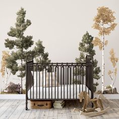 a baby's room with an iron crib and trees on the wall