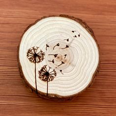 a piece of wood with dandelions on it