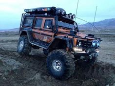 an off - road vehicle is driving through the mud