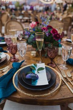 the table is set with place settings, napkins and wine glasses for guests to enjoy