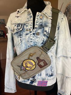 a denim jacket with patches on it and a fanny bag