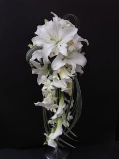 a bouquet of white flowers on a black background