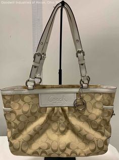 Certified Authentic Tan/White Coach Baguette Handbag Condition: Gently Loved Purse Type & Closure: Baguette Handbag, Zipper Serial Number: A1026-F14281 Color & Material: Tan/White, Fabric/Leather Approximate Measurements (inches): 4.5 x 8.5 x 12 x 9 strap drop Thank You for shopping with GIA Blue Boutique! We are a charitable organization with a mission to help individuals prepare for, find, and retain employment. Every purchase directly impacts this mission. Returns: All Sales are AS-IS and FIN Vintage White Tote Shoulder Bag, Vintage White Handheld Shoulder Bag, Coach Cream Shoulder Bag With Handle Drop, Vintage White Bags With Gold-tone Hardware, Vintage White Shoulder Satchel, Vintage White Satchel With Handles, Vintage White Satchel For Everyday Use, White Coach Satchel With Dust Bag, Classic Cream Shoulder Bag With Handles