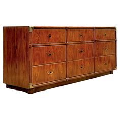 an old wooden dresser with six drawers and brass pulls on the front, against a white background