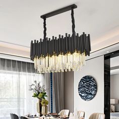 a dining room table with chairs and a chandelier hanging from the ceiling over it