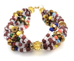 AGAYU - Santeria bead Maso Bracelet/Ilde Brown Crystal Bracelet With Faceted Round Beads, Brown Crystal Bracelet With Colorful Round Beads, Santeria Beads, Yoruba Culture, Beading, Jewelry Bracelets, Beaded Necklace, Beaded Bracelets, Ships