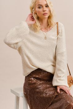 -Color: Cream -Soft touch polyester acrylic yarn with sparkling sequins -V-neck -Long sleeves -Loose fit -Ribbed on neck, cuffs and hem -Content: 65% Polyester 35% Acrylic -Imported -Model is 5'10" 31-25-35 and wearing a size Small Sequin Sweater, Acrylic Yarn, Sequin Skirt, Knitted Sweaters, Loose Fitting, Yarn, Size Small, V Neck, Cream