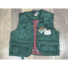 This Green Rio Bravo By Prestige Men's Xl Hunting/Fishing Vest Is A Must-Have For Any Outdoor Enthusiast. With A V-Neck Collar Style, Buckle Accents, And Multiple Pockets, This Vest Is Perfect For Small Game Hunting And Fishing. The Vest Features 18 Pockets With Zippers And Snaps, Providing Ample Storage Space For All Your Fishing And Hunting Gear. Made From A Cotton/Polyester Blend, This Vest Is Machine Washable And Perfect For All Four Seasons. The Closure Is A Hook And Loop Design, Ensuring A Utility Outerwear With Multiple Pockets For Camping, Casual Camping Outerwear With Pockets, Casual Outerwear With Pockets For Camping, Winter Fishing Outerwear With Pockets, Utility Outerwear With Pockets For Fishing, Mens Black Vest, Vintage Leather Vest, Mens Vest Jacket, Game Hunting