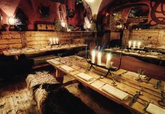 the interior of a restaurant with candles lit