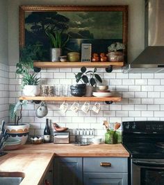 the kitchen is clean and ready for us to use it's shelves are filled with dishes