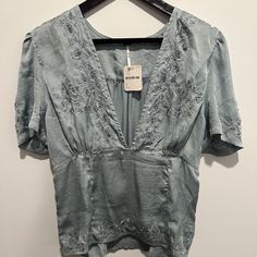 Nwt Free People Short-Sleeve Deep-V Shirt In Blue (Medium Blue) (Size L). Shirt Features A Deep-V At The Front With Darting At The Midriff. Extensive Embroidery With Lace Insets At The Neckline, Hemline, On The Sleeves, And On The Back. Center Back Is Elasticized To Provide Stretch And Freedom Of Movement. Shirt Is Completely Brand New, Never Used. Perfect Condition. No Flaws, Damage, Or Imperfections Whatsoever. Super Cute Shirt! Perfect For So Many Occasions. Floral Embroidered V-neck Top With Relaxed Fit, Relaxed Fit V-neck Embroidered Top With Floral Embroidery, Relaxed Fit V-neck Top With Floral Embroidery, Casual Blue Embroidered V-neck Top, Spring Embroidered V-neck Top With Relaxed Fit, V-neck Embroidered Top For Spring With Relaxed Fit, Blue V-neck Top With Floral Embroidery, Chic V-neck Top With Floral Embroidery, Chic V-neck Tops With Floral Embroidery