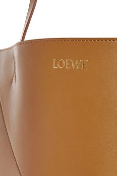 [vc_row][vc_column width=”1/3″][vc_column_text text_larger=”no”] LOEWE LOEWE XL Puzzle Fold Tote in shiny calfskin The Puzzle Fold Tote takes the iconic bag’s signature geometric lines and reimagines them in graphic and architectural panels that allow the bag to fold completely flat, making it the perfect travel companion. Soft, lightweight and inventively crafted, it is finished with discreet LOEWE branding. This XL version is crafted in shiny calfskin. LOEWE XL Puzzle F Rectangular Bags With Engraved Logo, Modern Top Handle Bags With Engraved Logo, Chic Bag With Engraved Logo, Designer Calf Leather Bags With Logo, Elegant Workwear Bags With Logo, Glossy Leather Tote Bag, Modern Rectangular Bag With Engraved Logo, Modern Rectangular Bags With Engraved Logo, Designer Leather Bag With Glossy Finish