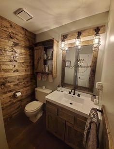 a bathroom with wood paneling and a white toilet