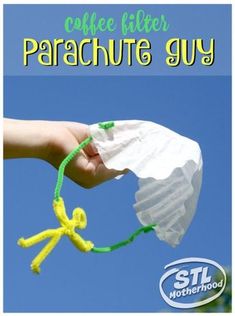 a hand holding a paper bag with a string attached to it and the words coffee filter parachute guy